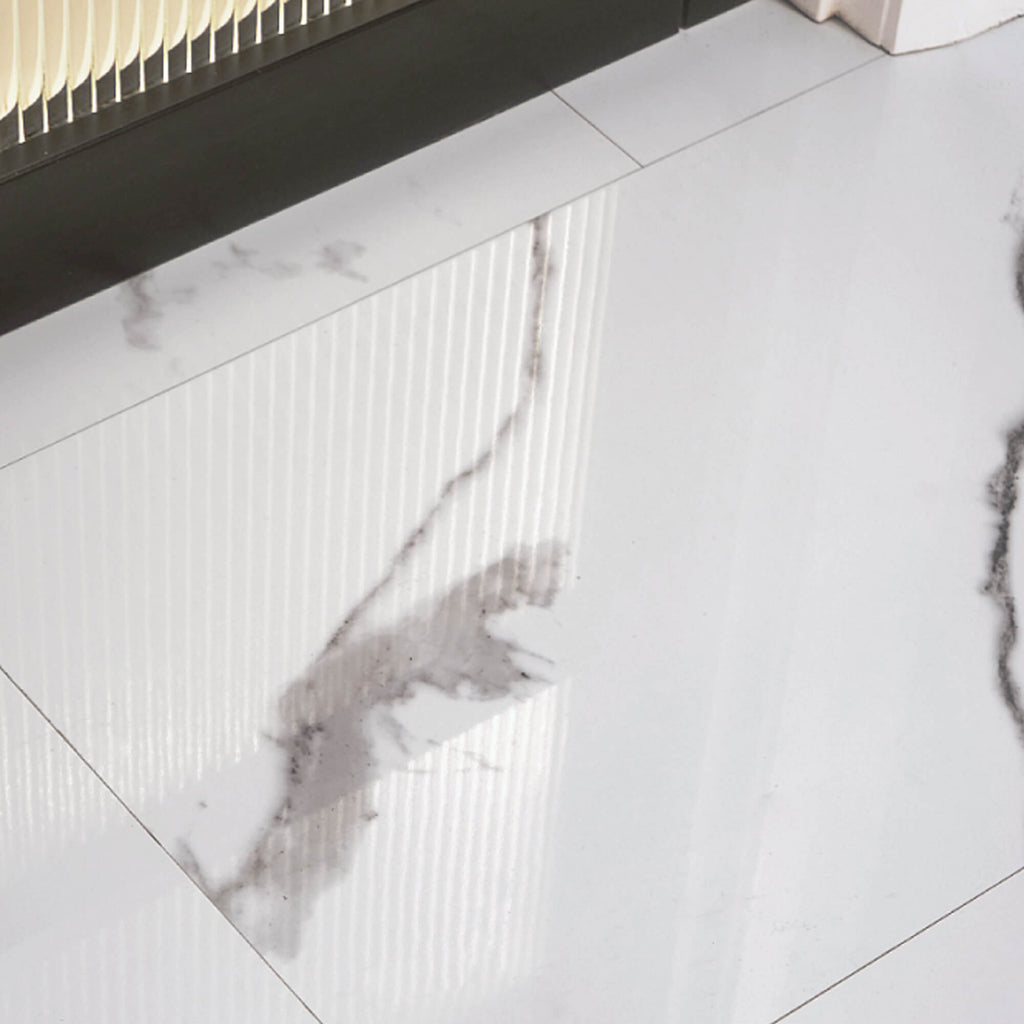 Close-up of a Calacatta Marble Gloss Rigid LVT Floor Tile offset by a black glazed door.