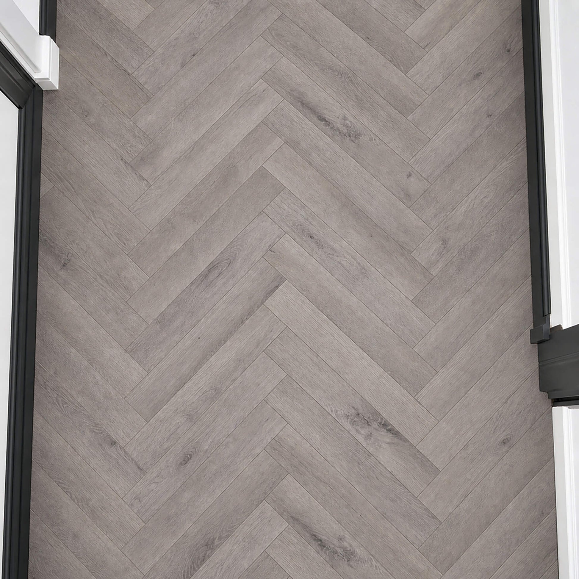 Elevated view of Castle Grey Herringbone laminate flooring.
