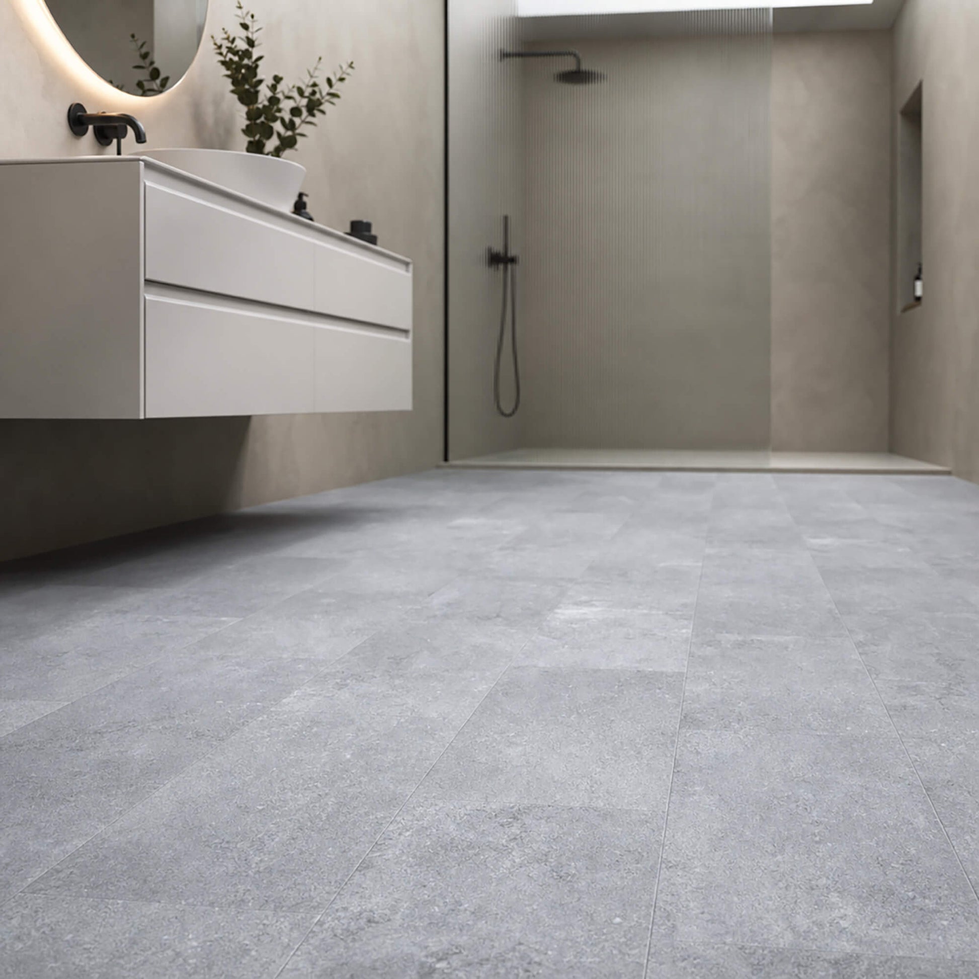 Claros Grey Rigid LVT tile flooring in a bathroom setting with sink and shower area.