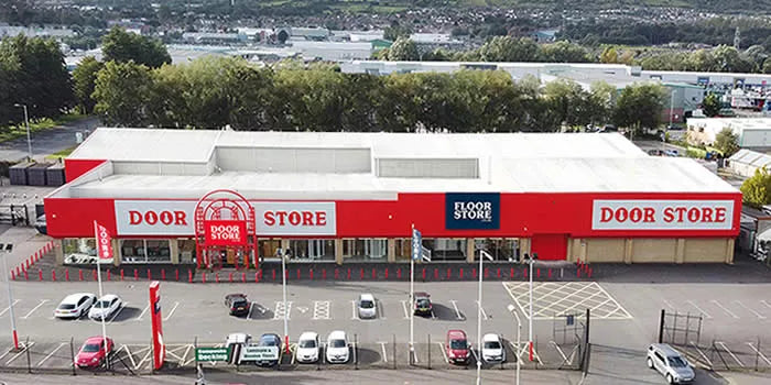 Red and white store building with 'Door Store' branding on a clear day.
