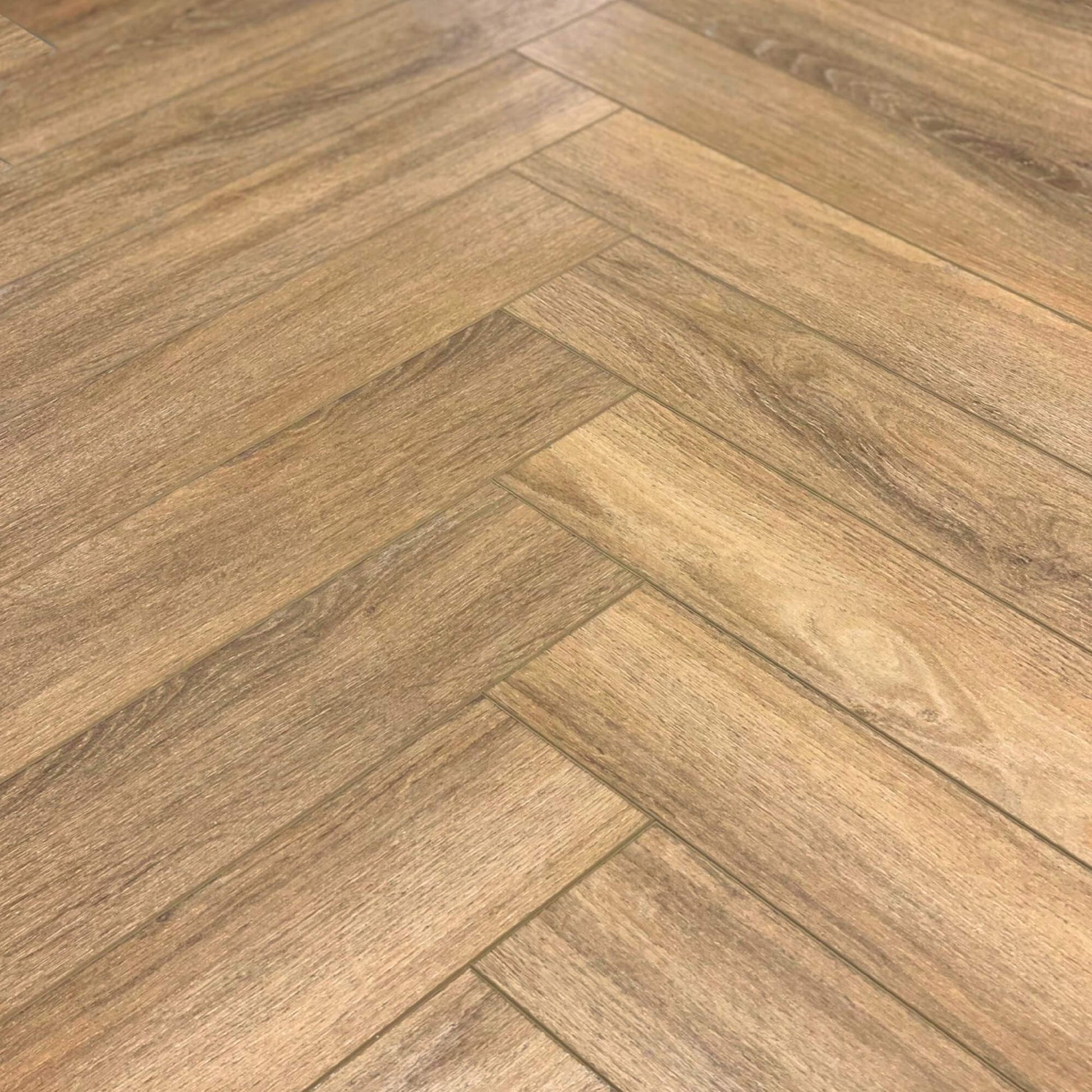 Close-up of the Forest Oak Rigid LVT Herringbone flooring grain