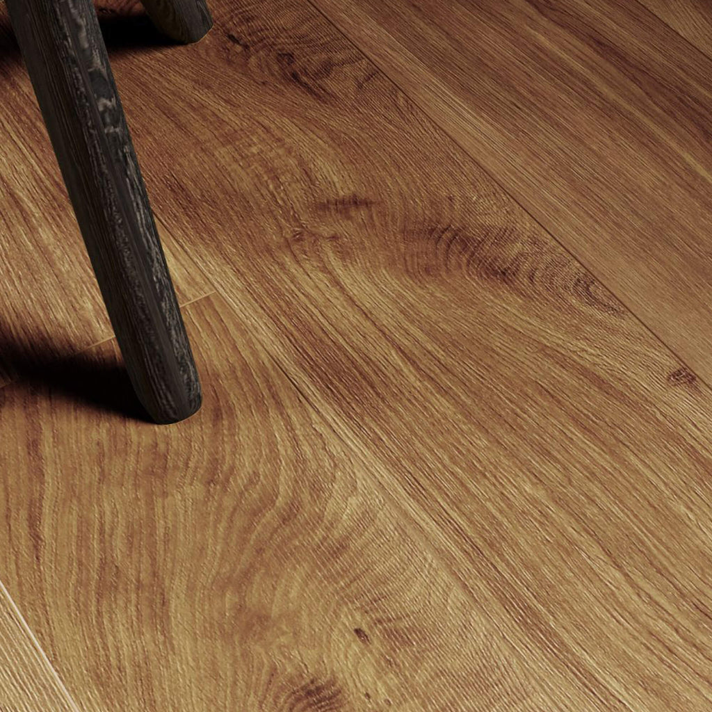 Close-up of Groovy Oak Country Laminate Flooring with a leg of a stool in the corner.
