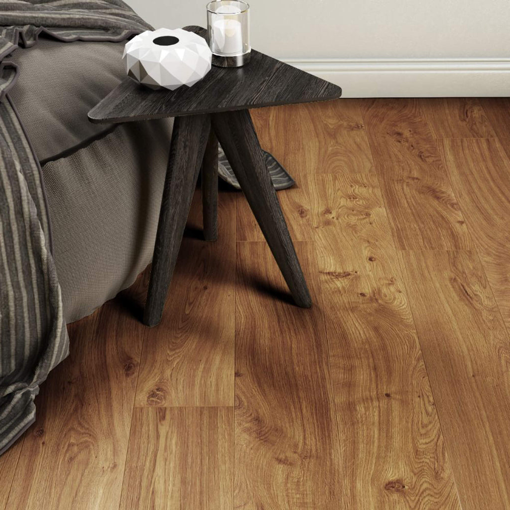 Groovy Oak Country Laminate Flooring in a living room setting with a sofa and side table