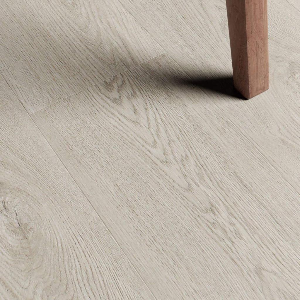 Close-up of Marino Grey Rigid LVT flooring with a wooden leg partially visible