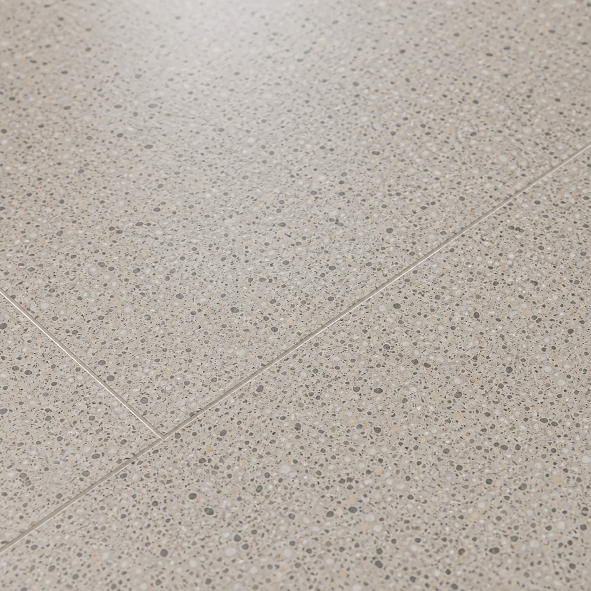 Close-up of Milano Terrazzo Rigid LVT floor tiles.