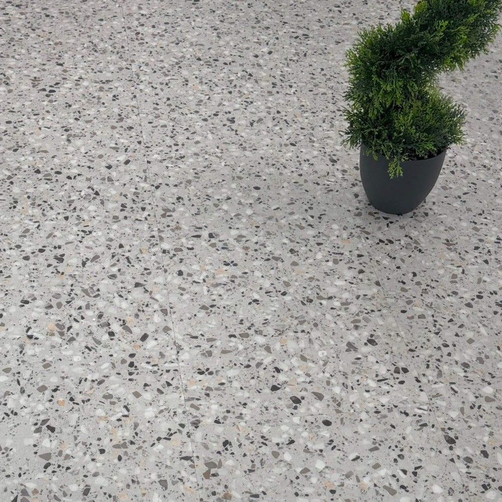 Milano Terrazzo Rigid LVT Floor Tiles on a floor with a plant in the corner.