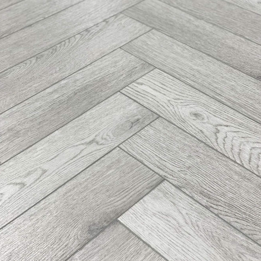 Close-up of Pyrenees Oak Rigid LVT Herringbone Flooring