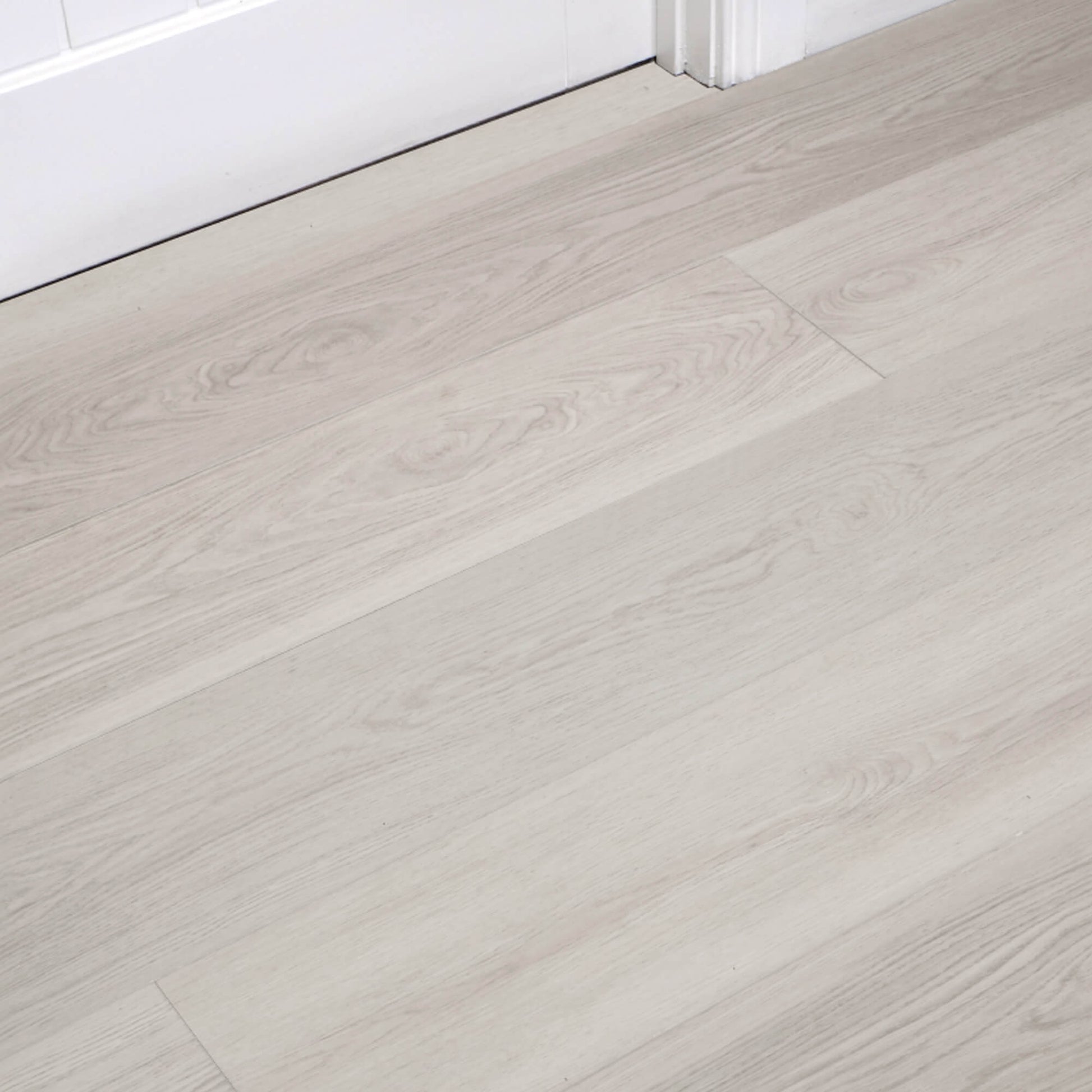 Siberian Oak Rigid LVT flooring with a white architrave  and door in the background