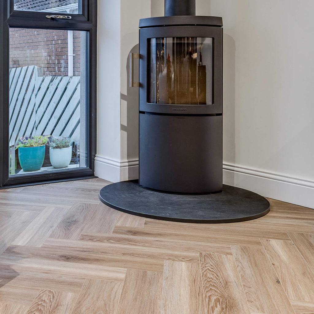 Volcanic Larch Rigid LVT Herringbone Flooring in a sun room setting.